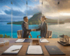 Poignée de main professionnelle lors de la signature d'un contrat de fonds de commerce avec vue sur Moorea depuis un bureau vitré à Tahiti